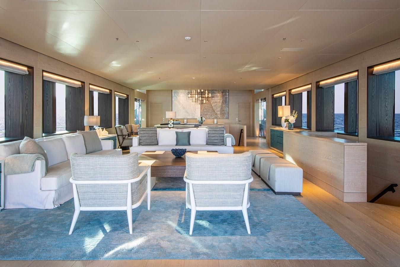 a large living room with white chairs aboard SANAM Yacht for Sale
