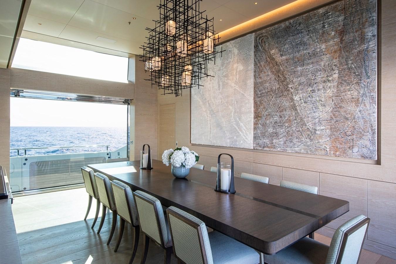 a dining table in a room aboard SANAM Yacht for Sale