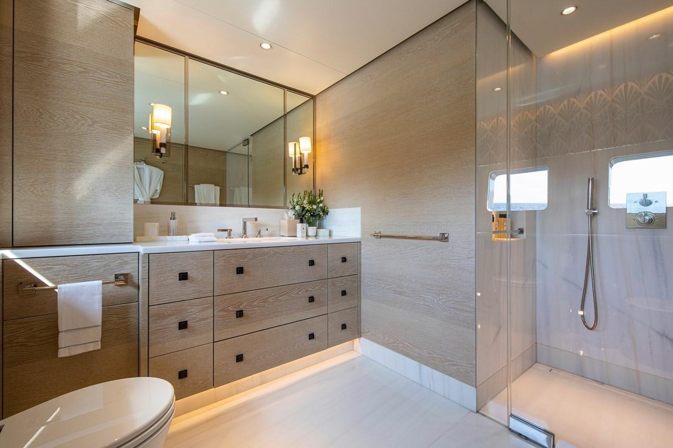 a bathroom with a glass shower aboard SANAM Yacht for Sale