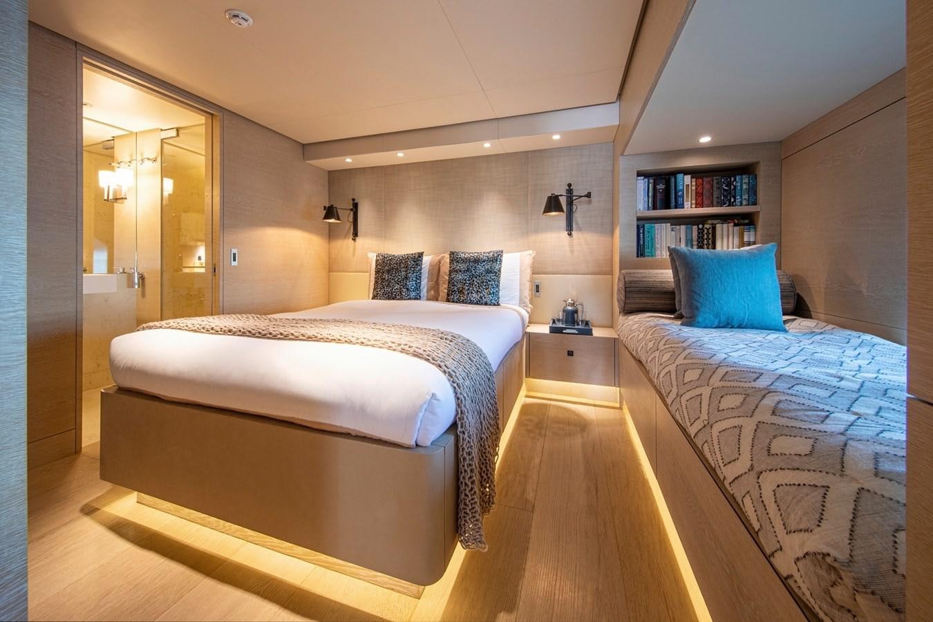 a couple of beds in a hotel room aboard SANAM Yacht for Sale