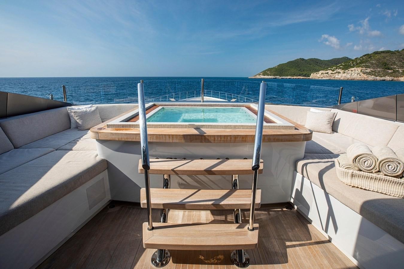 a deck with a pool and a deck overlooking the ocean aboard SANAM Yacht for Sale