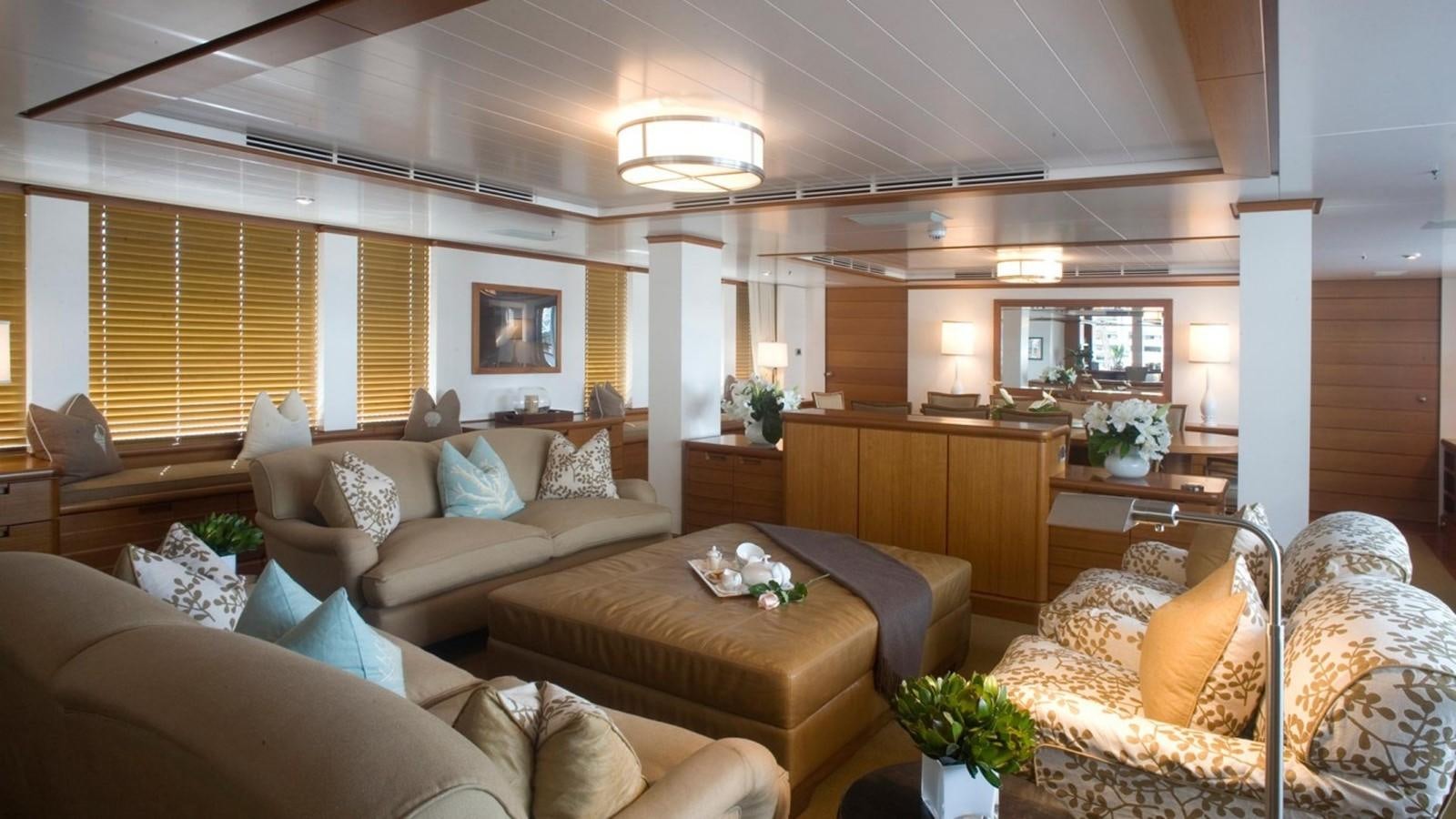a living room with a couch and a coffee table aboard HADIA Yacht for Sale