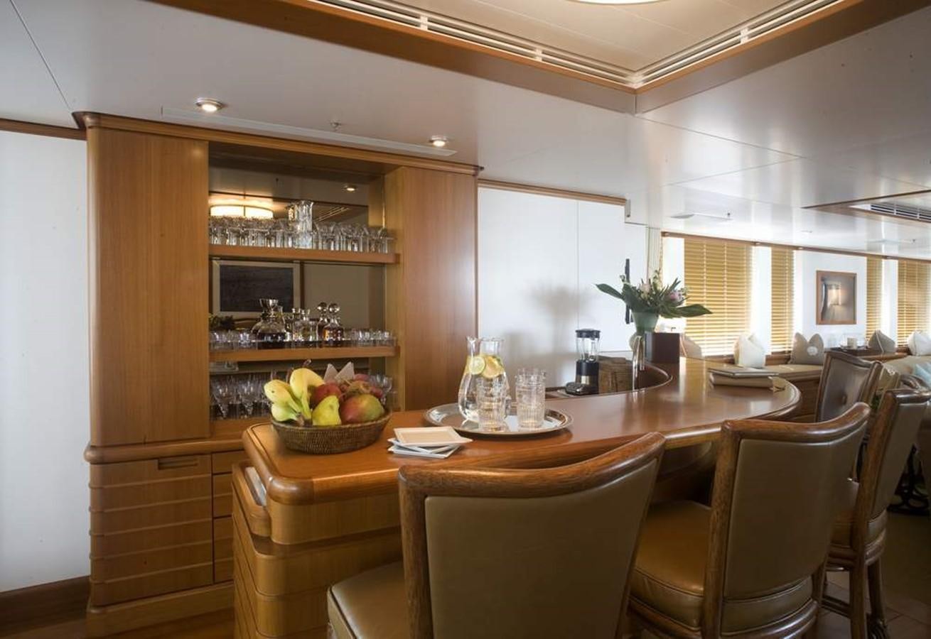 a kitchen with a table and chairs aboard HADIA Yacht for Sale
