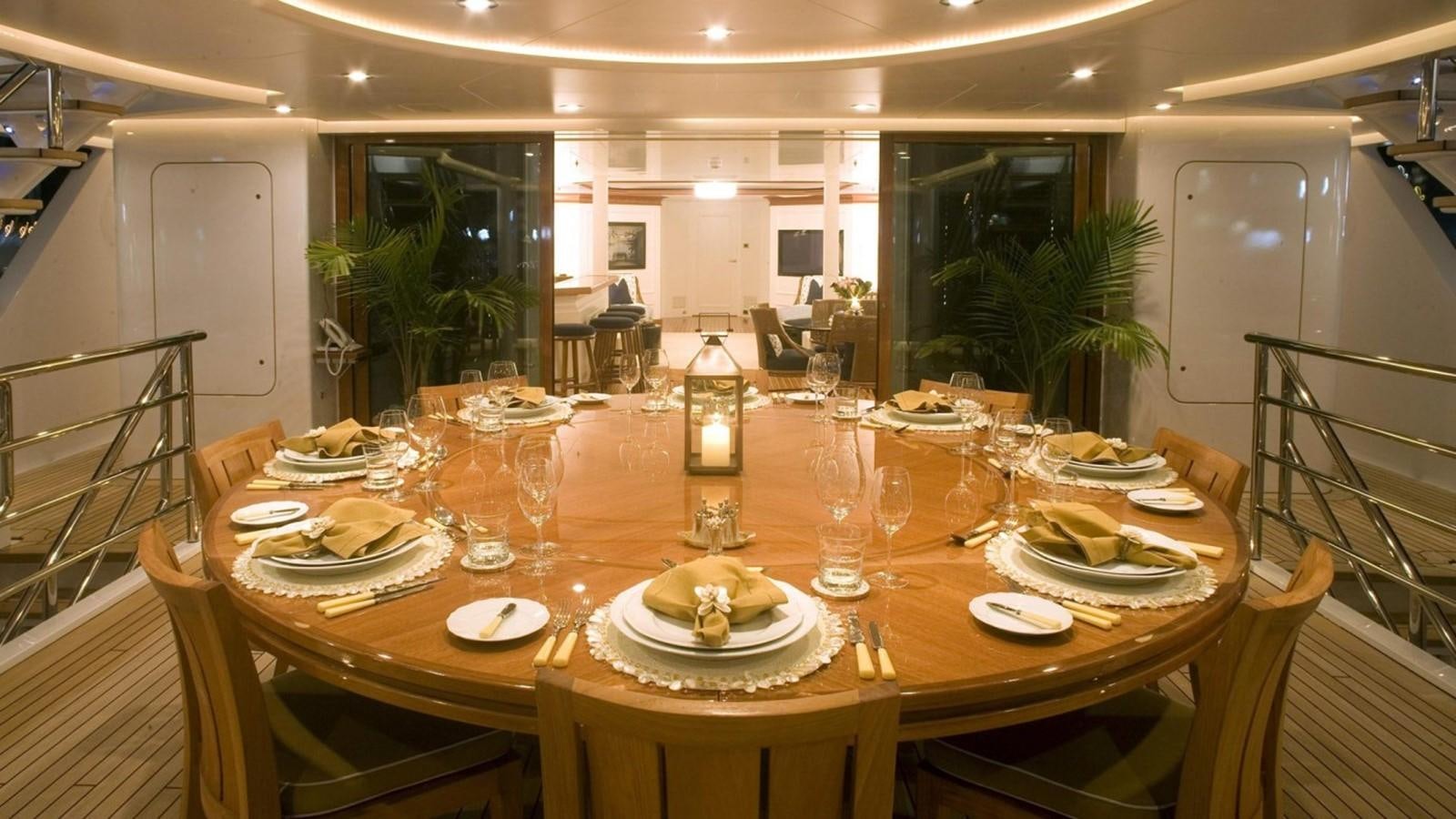 a table set for a dinner party aboard HADIA Yacht for Sale