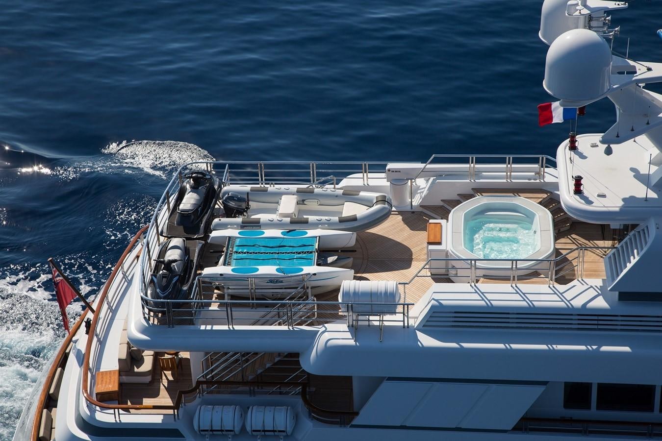 a boat with a deck and chairs on it aboard HADIA Yacht for Sale
