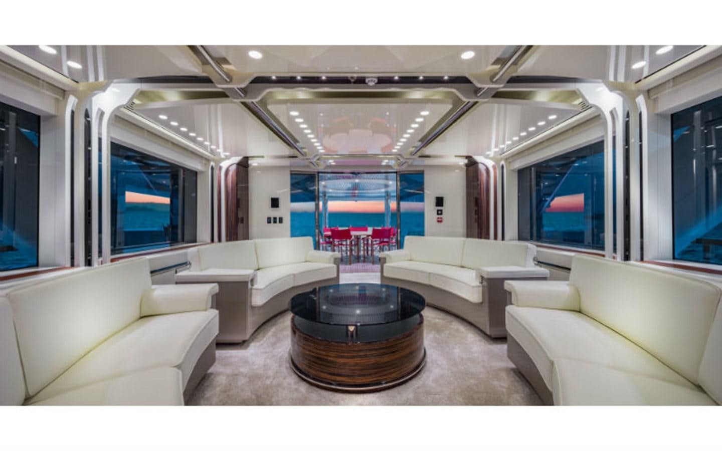 a living room with a round table aboard EUPHORIA Yacht for Sale