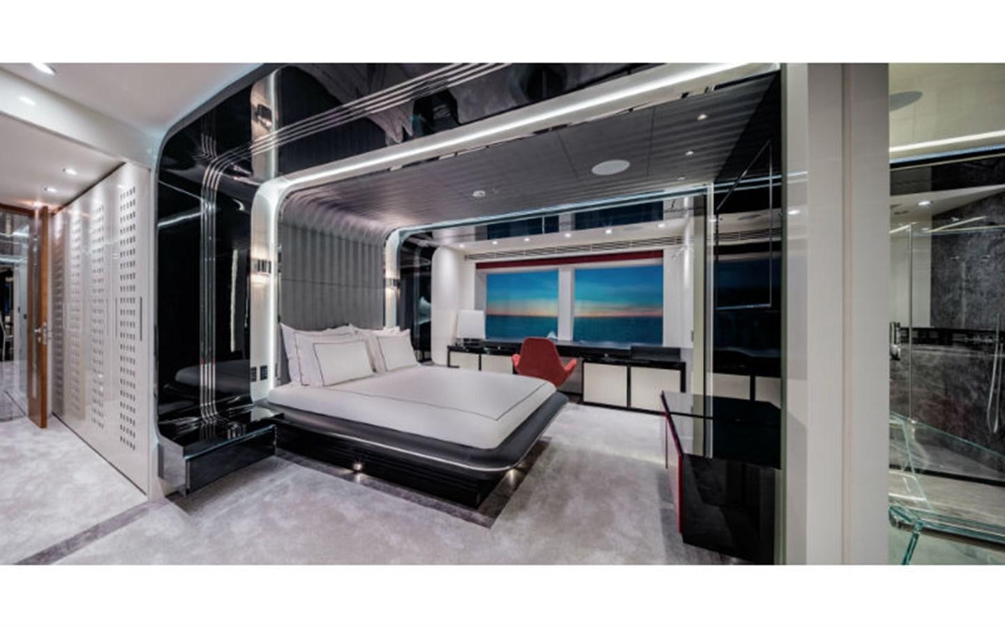 a room with a bed and a chair aboard EUPHORIA Yacht for Sale