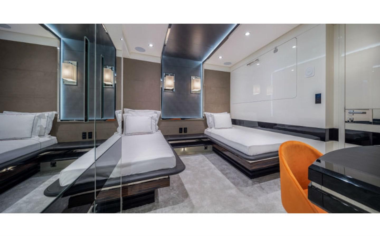 a room with a bed and a chair aboard EUPHORIA Yacht for Sale
