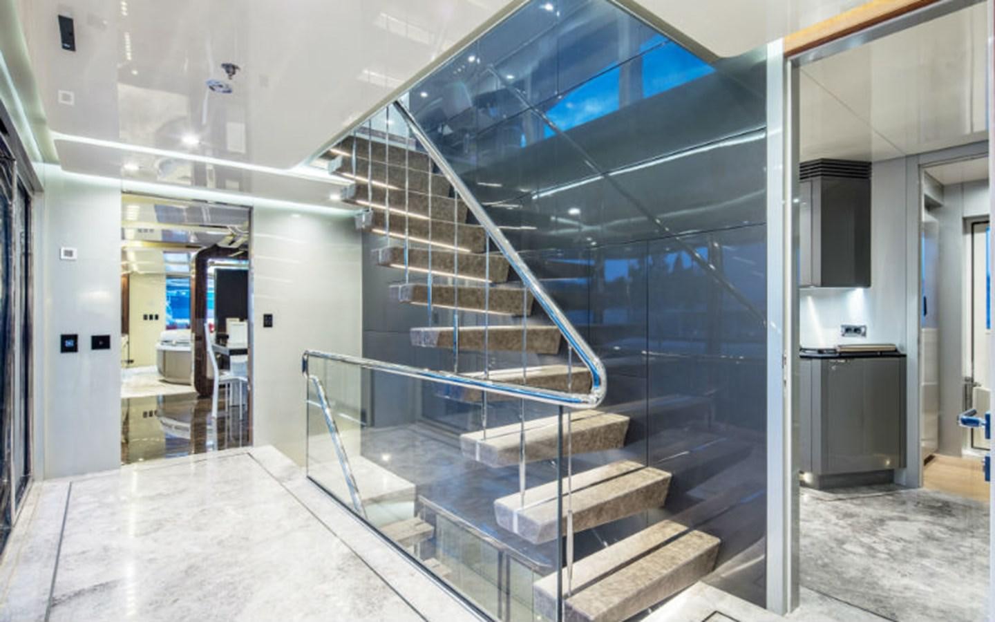a large room with a staircase aboard EUPHORIA Yacht for Sale