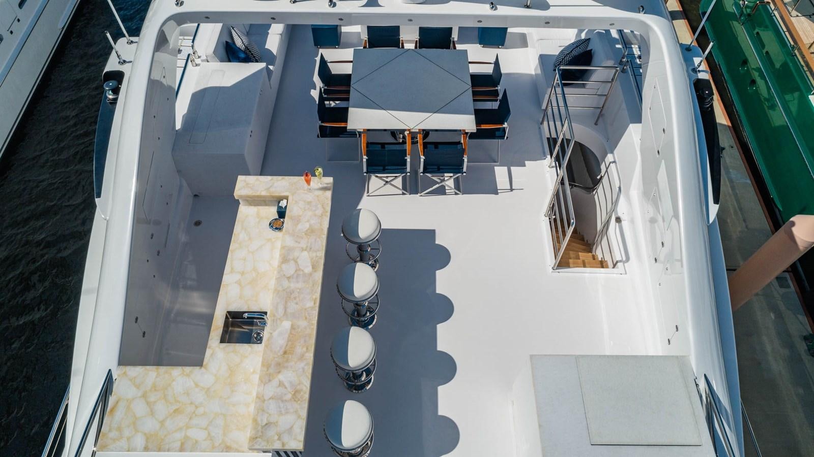 a large white boat with a deck and chairs on it aboard APRICITY Yacht for Sale