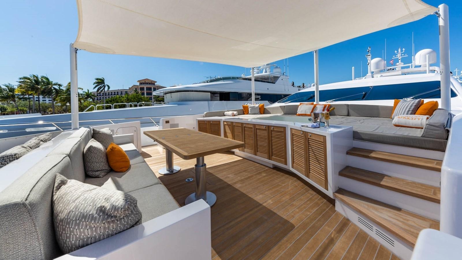 a deck with a couch and a pool aboard APRICITY Yacht for Sale