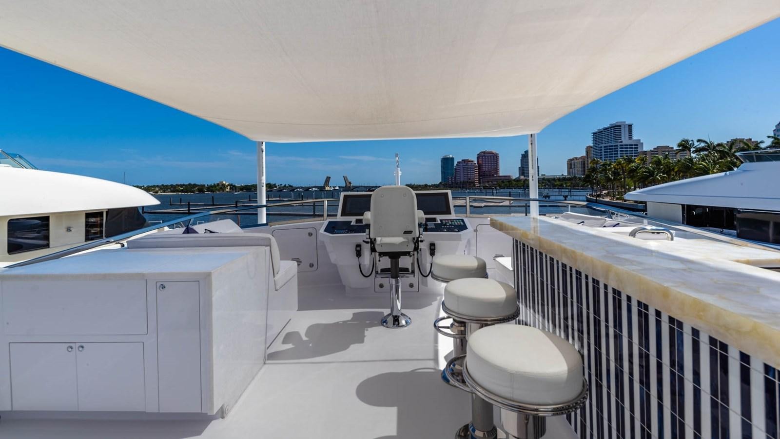 a deck with chairs and tables aboard APRICITY Yacht for Sale