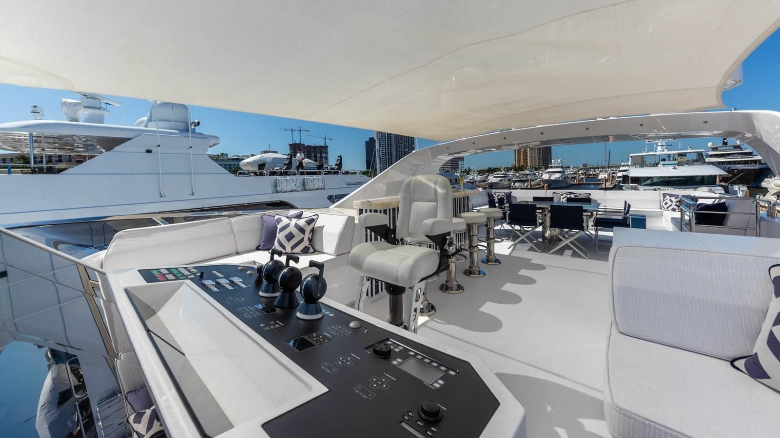 a room with a table and chairs aboard APRICITY Yacht for Sale