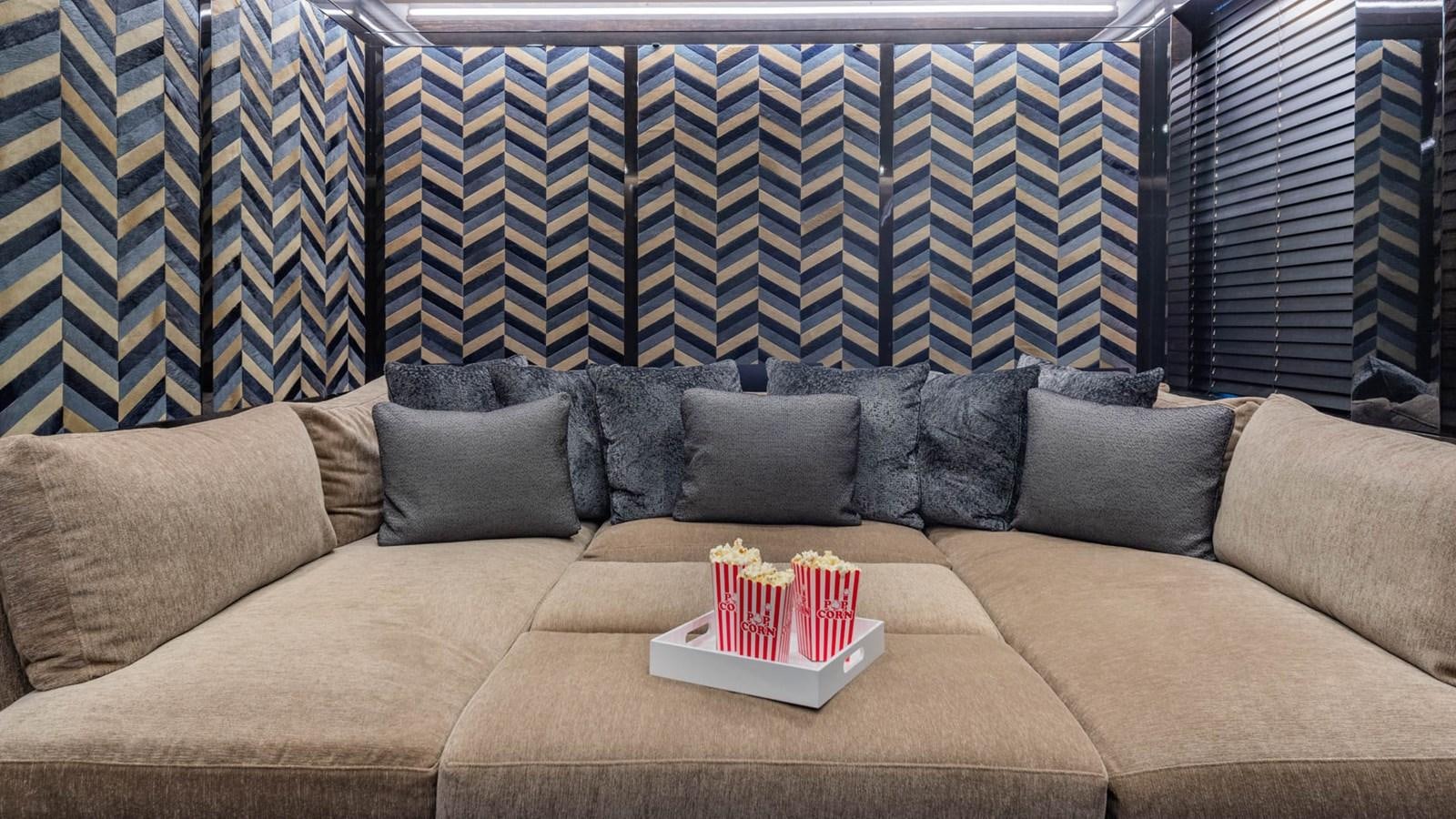 a couch with a coffee table and a couple of red boxes on it aboard APRICITY Yacht for Sale