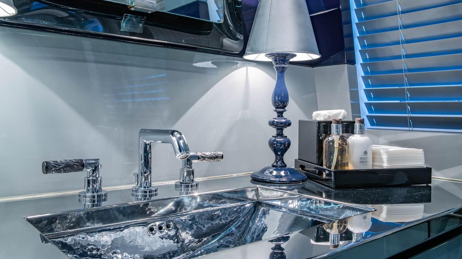 a bathroom sink with a mirror above it aboard APRICITY Yacht for Sale