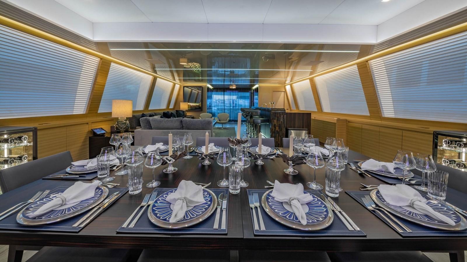 a table set with plates and glasses aboard APRICITY Yacht for Sale