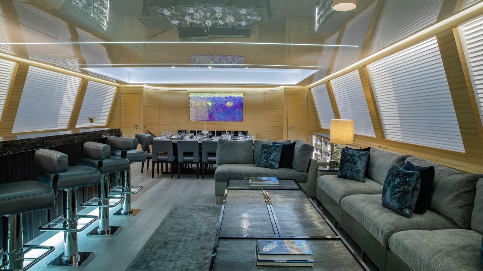 a large room with couches and a coffee table aboard APRICITY Yacht for Sale