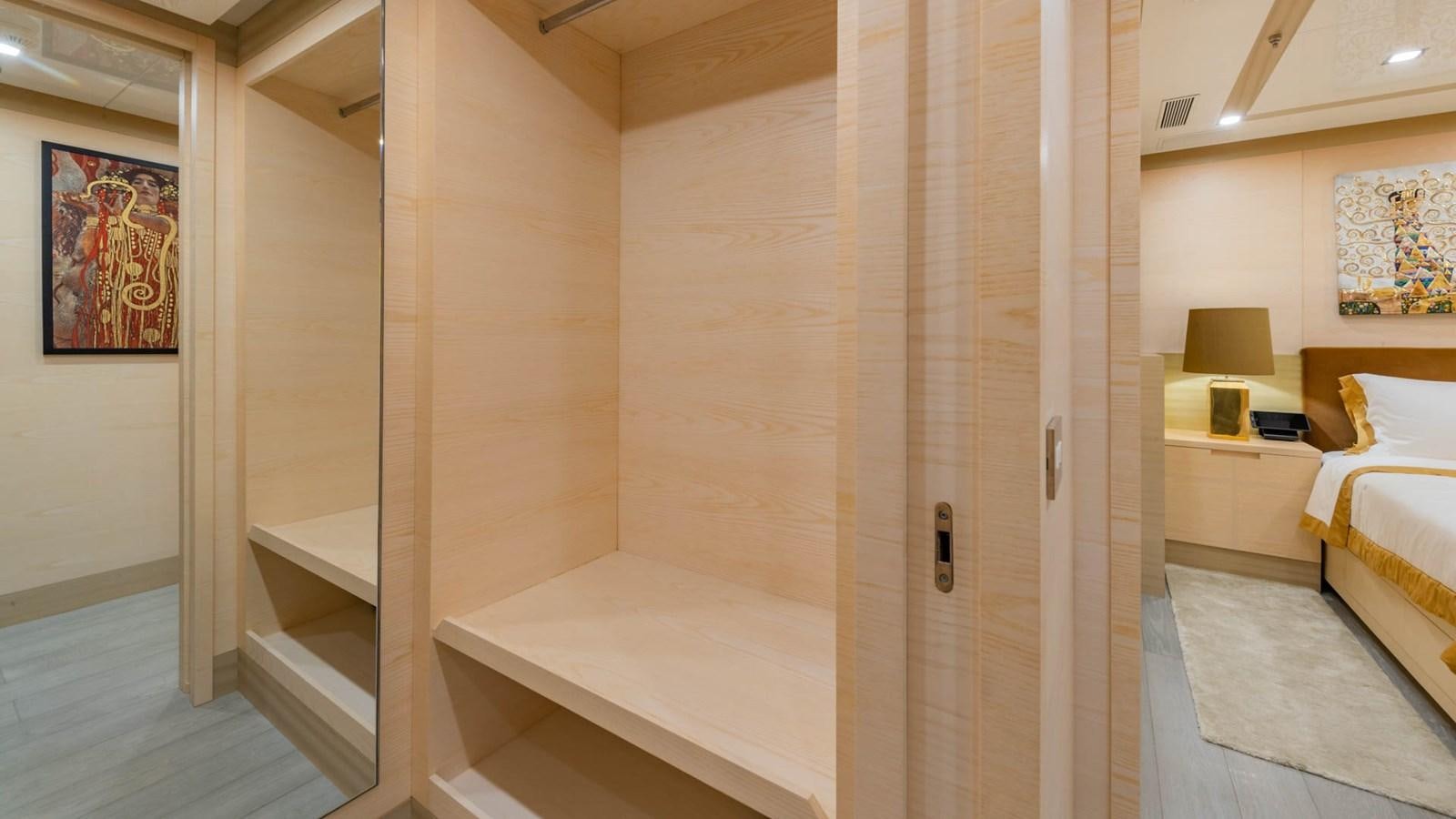 a room with a bed and a lamp aboard APRICITY Yacht for Sale