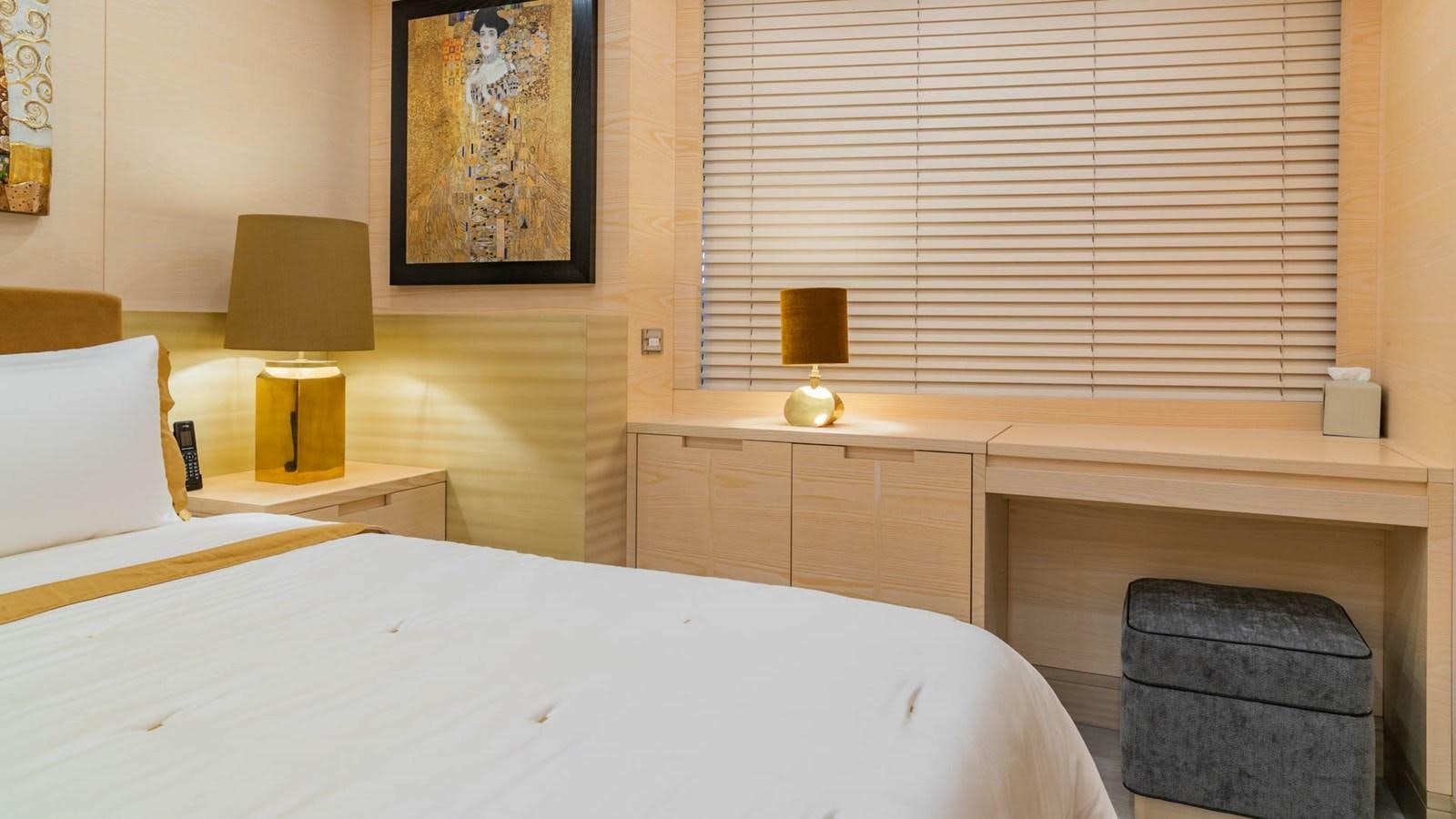 a room with a bed and a lamp aboard APRICITY Yacht for Sale