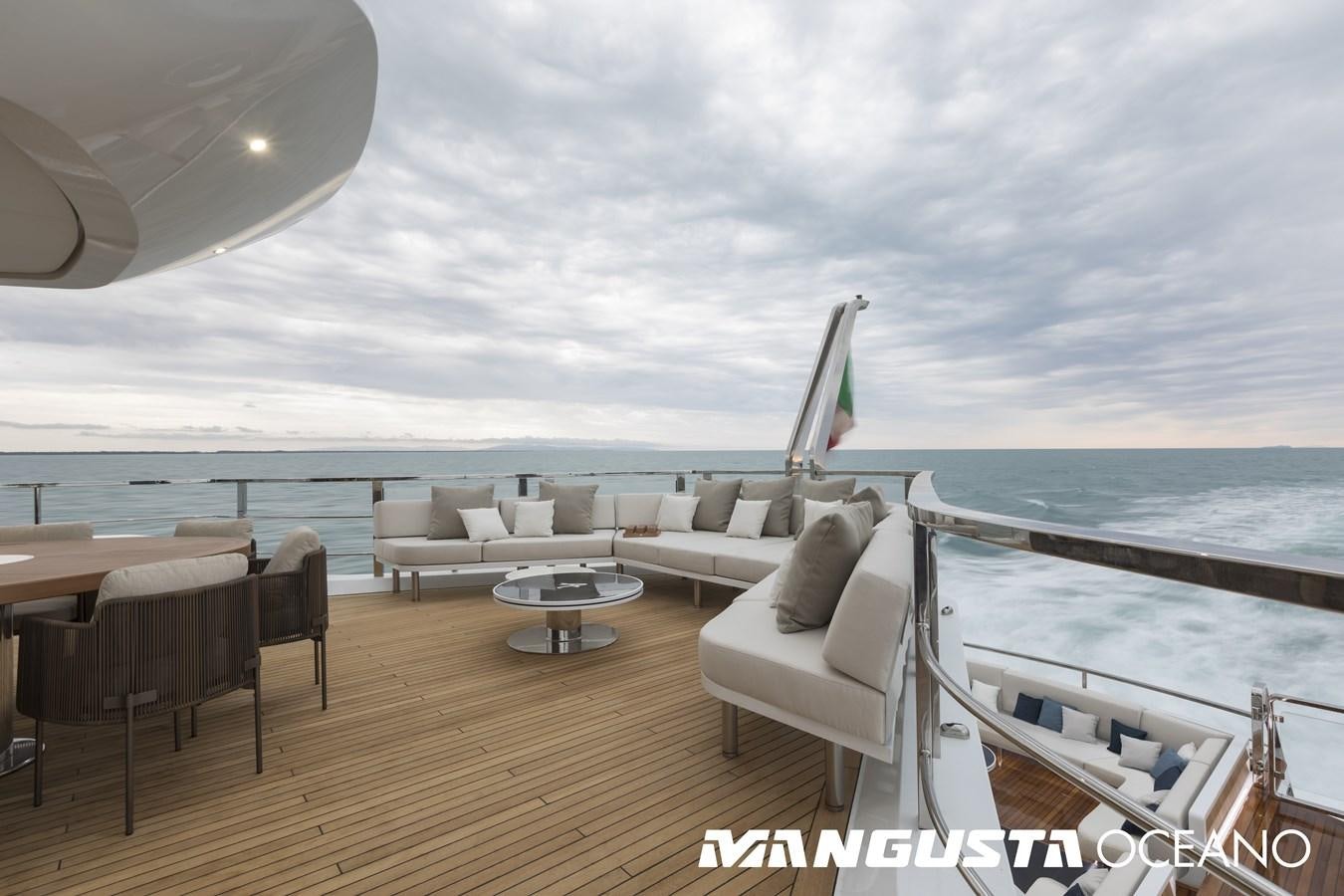a room with a couch and a table and a chair on a deck aboard MANGUSTA OCEANO 50/06 Yacht for Sale