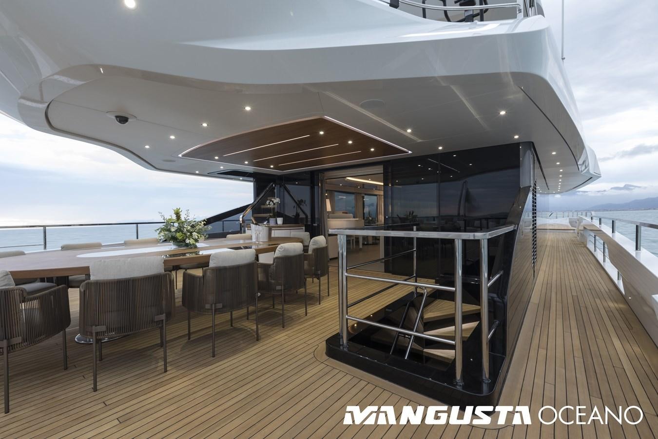 a deck with tables and chairs aboard MANGUSTA OCEANO 50/06 Yacht for Sale