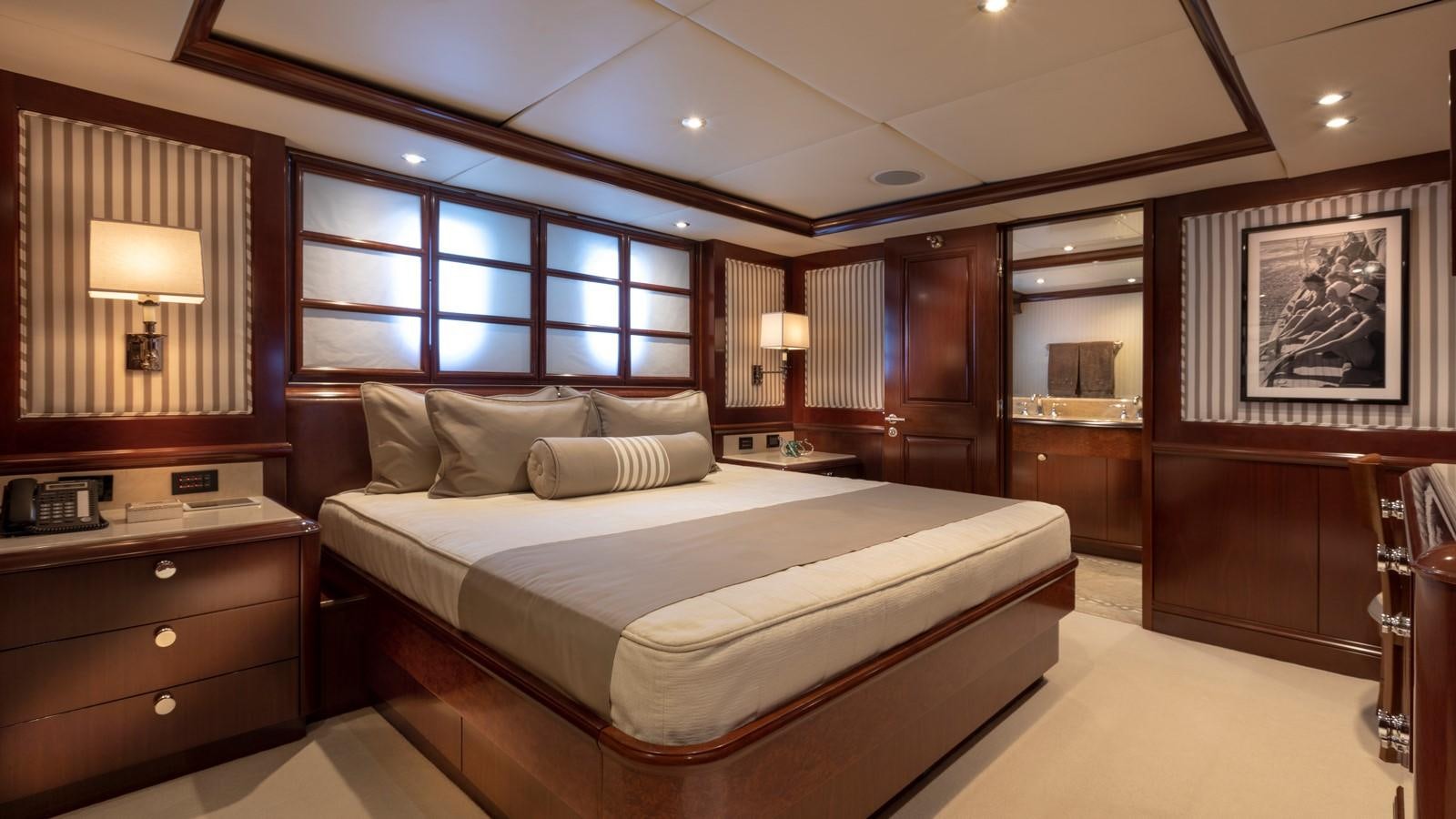 a bedroom with a bed and a desk aboard GLAZE Yacht for Sale