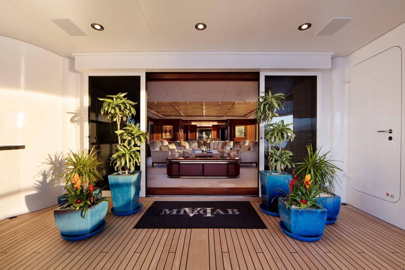 a living room with a wood floor aboard OLMIDA Yacht for Sale