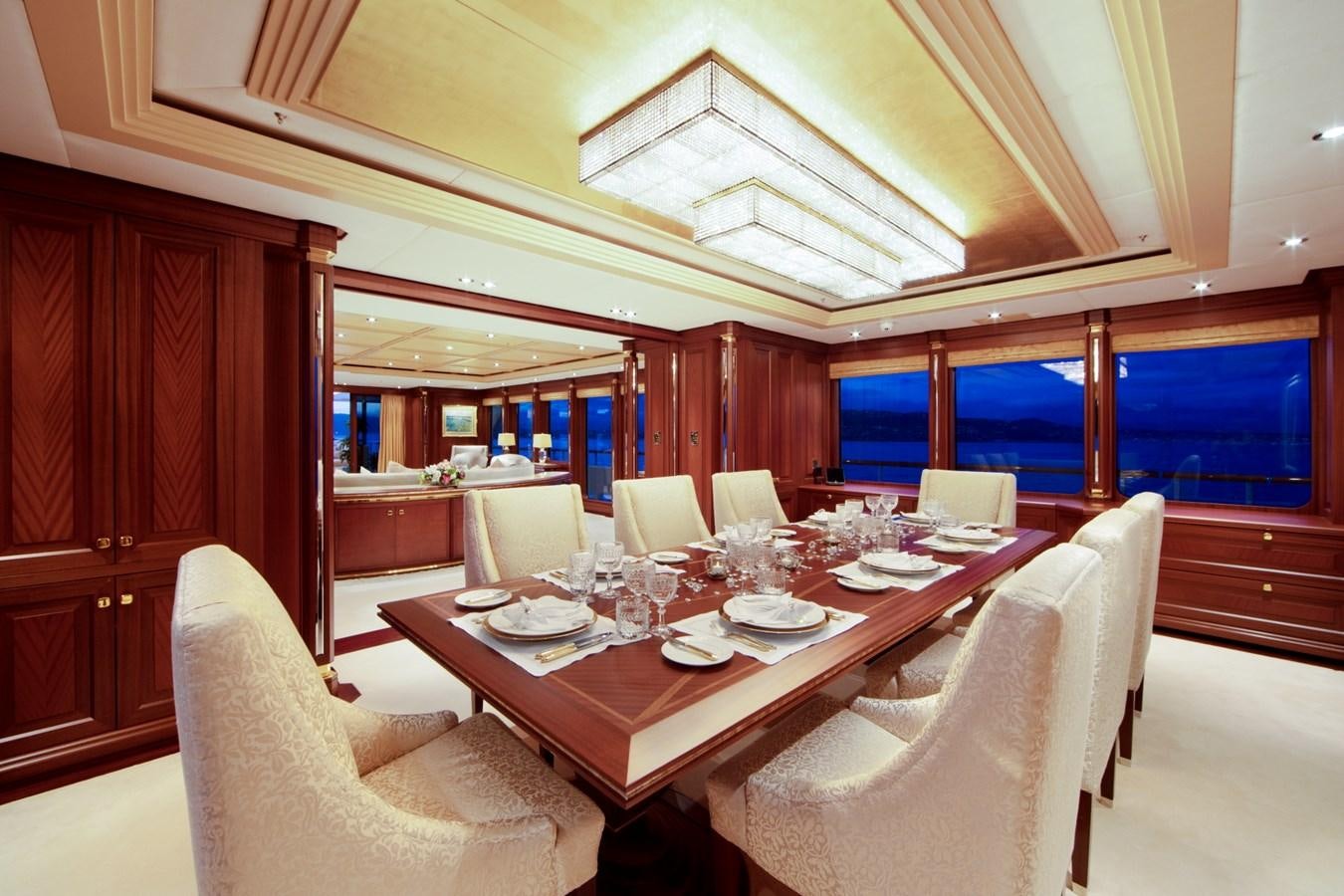 a dining table with chairs aboard OLMIDA Yacht for Sale