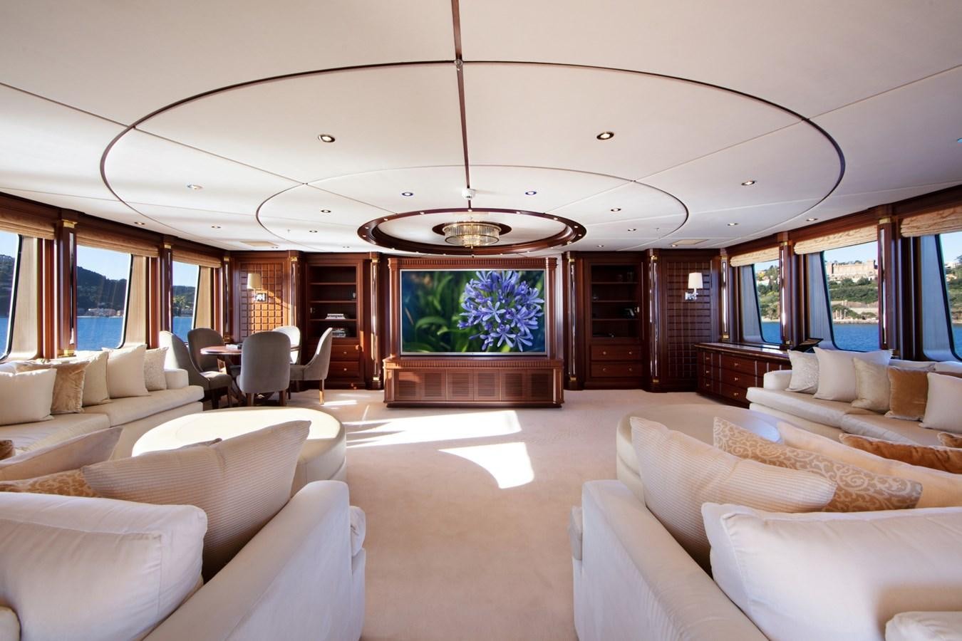 a living room with a large screen aboard OLMIDA Yacht for Sale