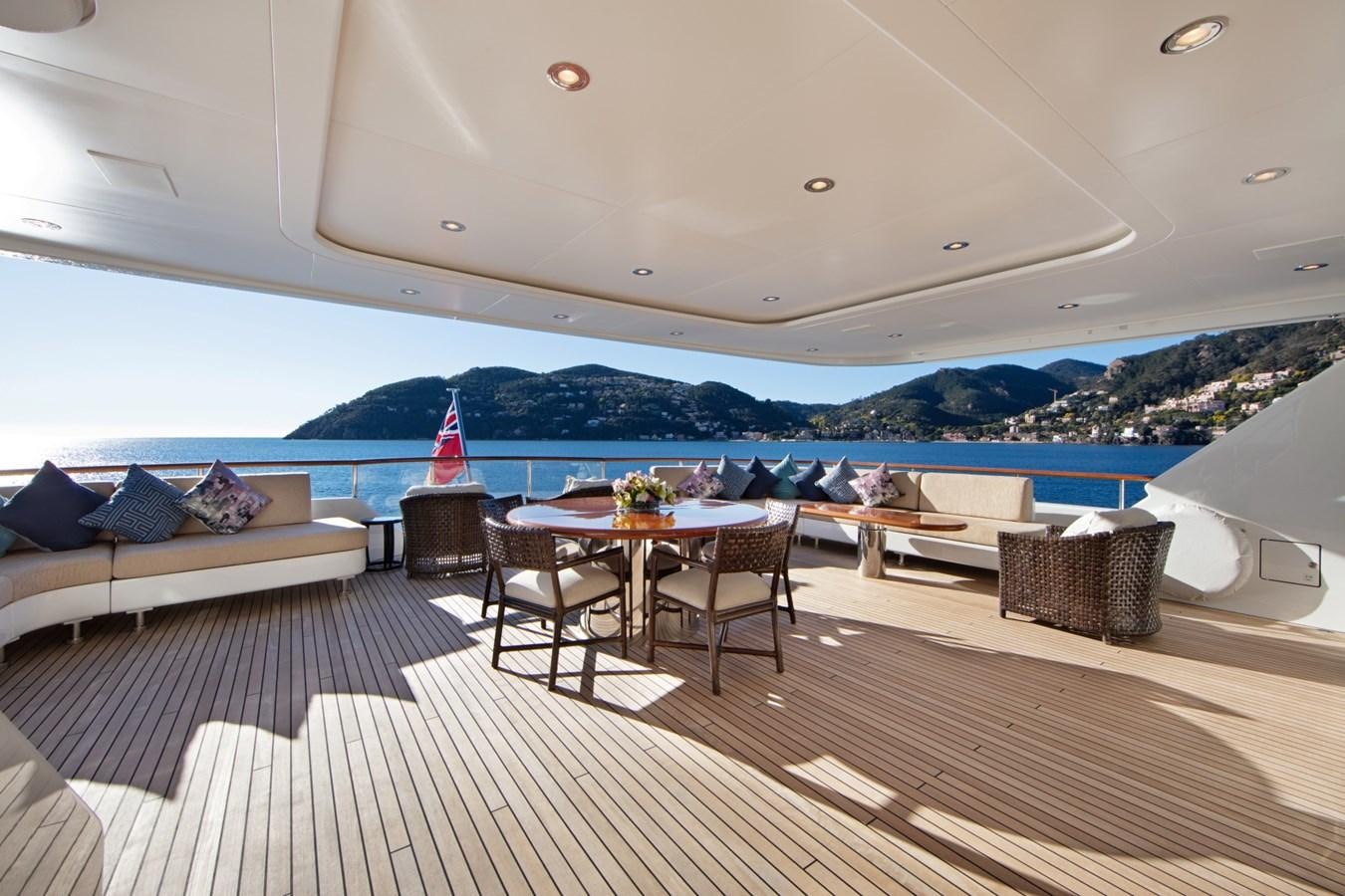 a room with a table and chairs aboard OLMIDA Yacht for Sale