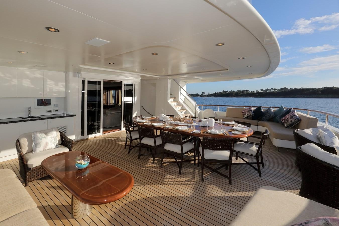 a living room with a table and chairs aboard OLMIDA Yacht for Sale