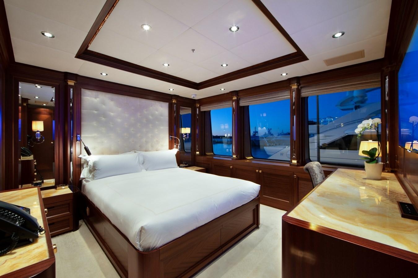 a room with a bed and a desk aboard OLMIDA Yacht for Sale