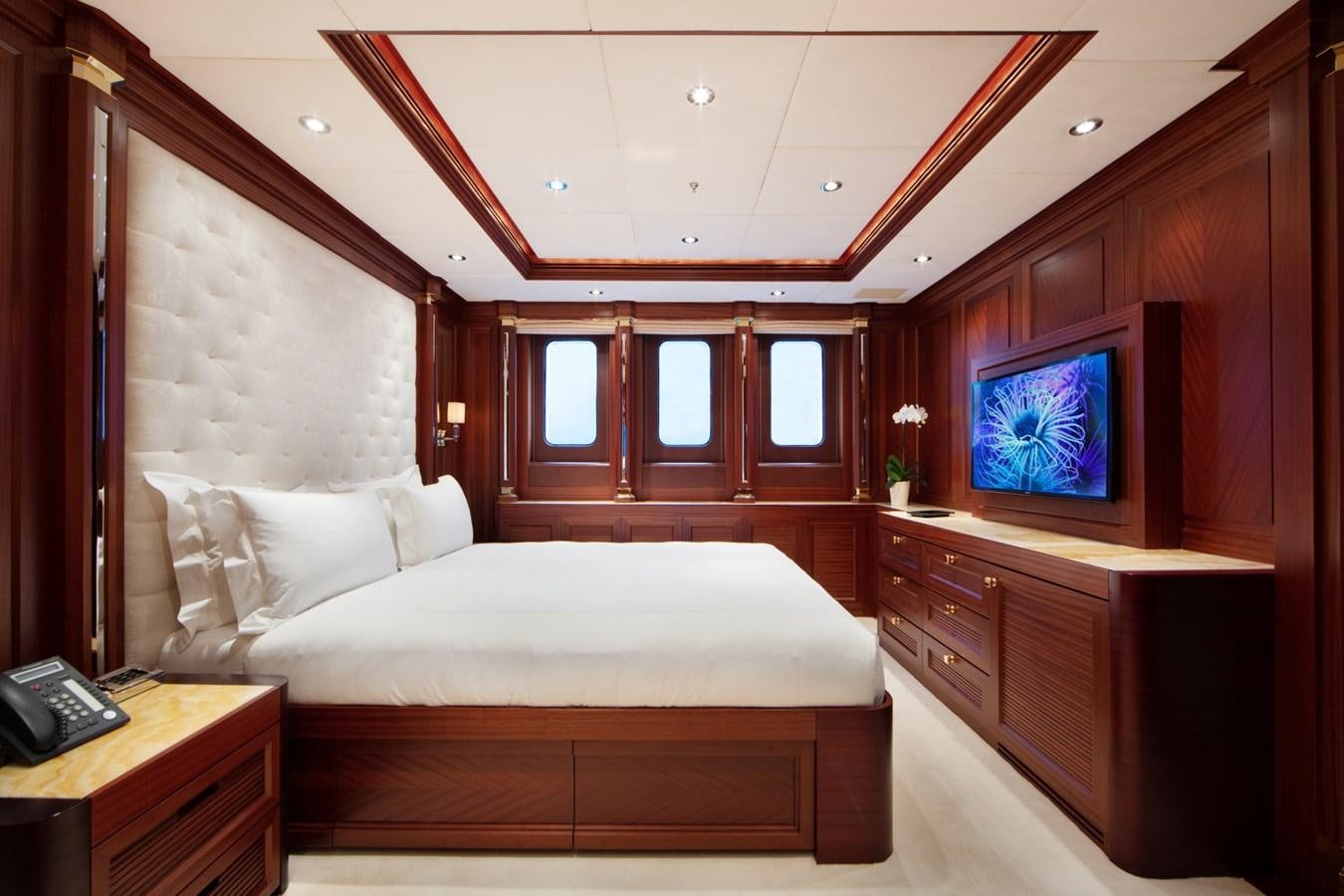 a bedroom with a bed and a television aboard OLMIDA Yacht for Sale