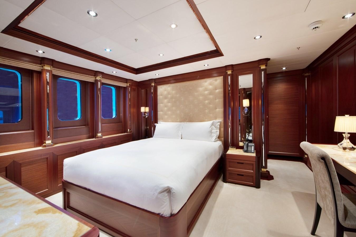 a room with a bed and a desk aboard OLMIDA Yacht for Sale