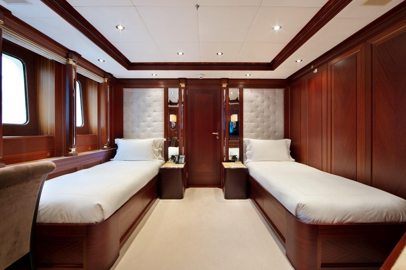 a room with beds and a mirror aboard OLMIDA Yacht for Sale