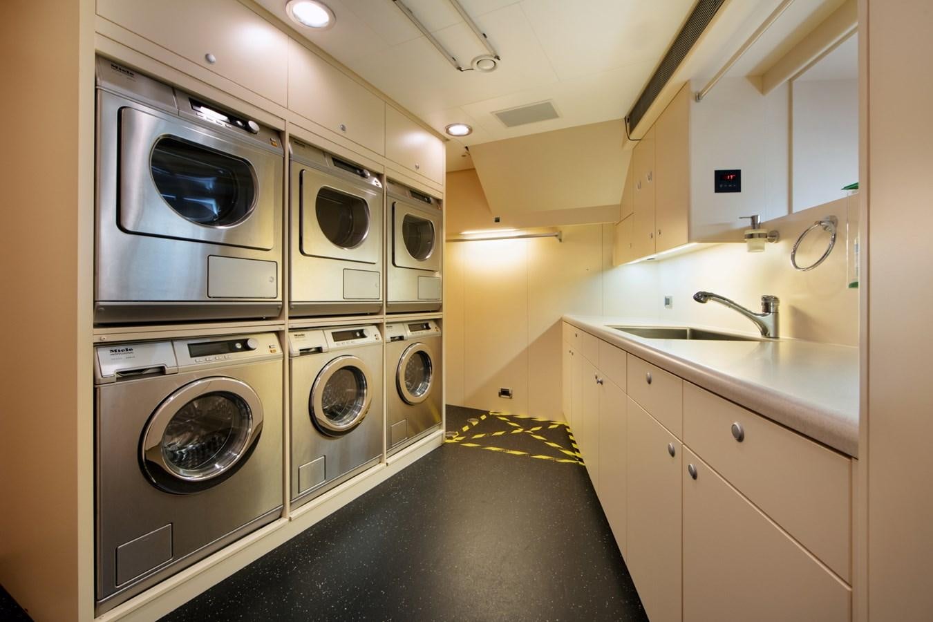 a large washer and dryer in a room aboard OLMIDA Yacht for Sale