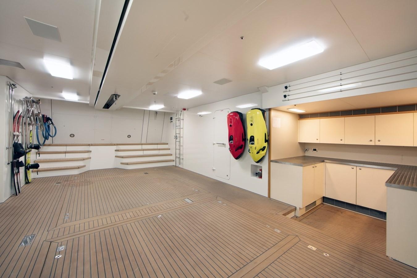 a room with a wood floor and a large mirror on the wall aboard OLMIDA Yacht for Sale