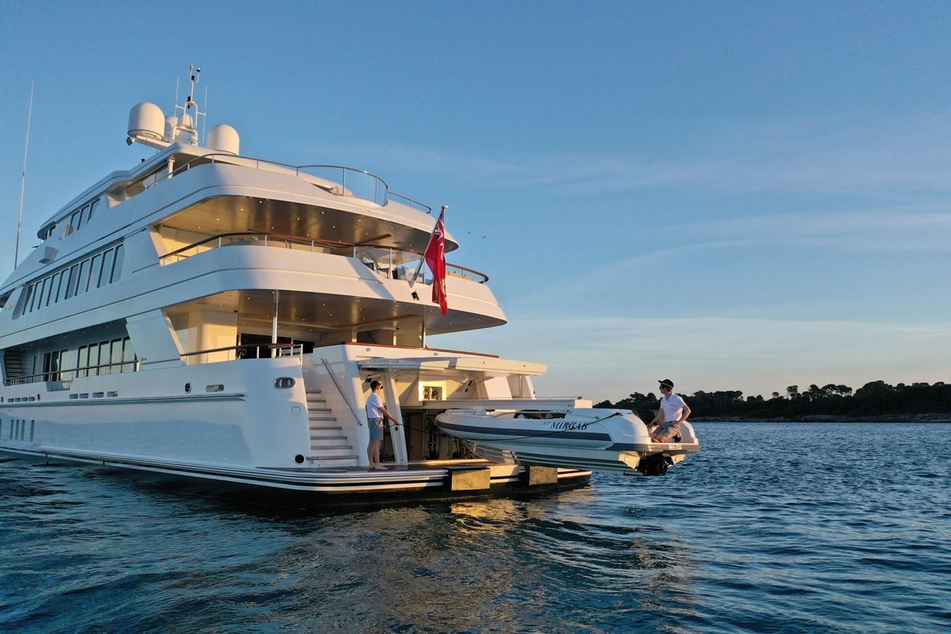 a large white boat with a couple of people on it aboard OLMIDA Yacht for Sale