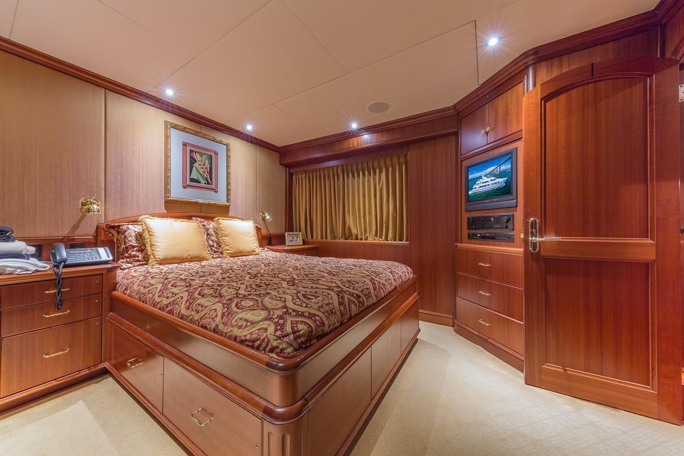 a bedroom with a bed and a tv aboard SORCHA Yacht for Sale