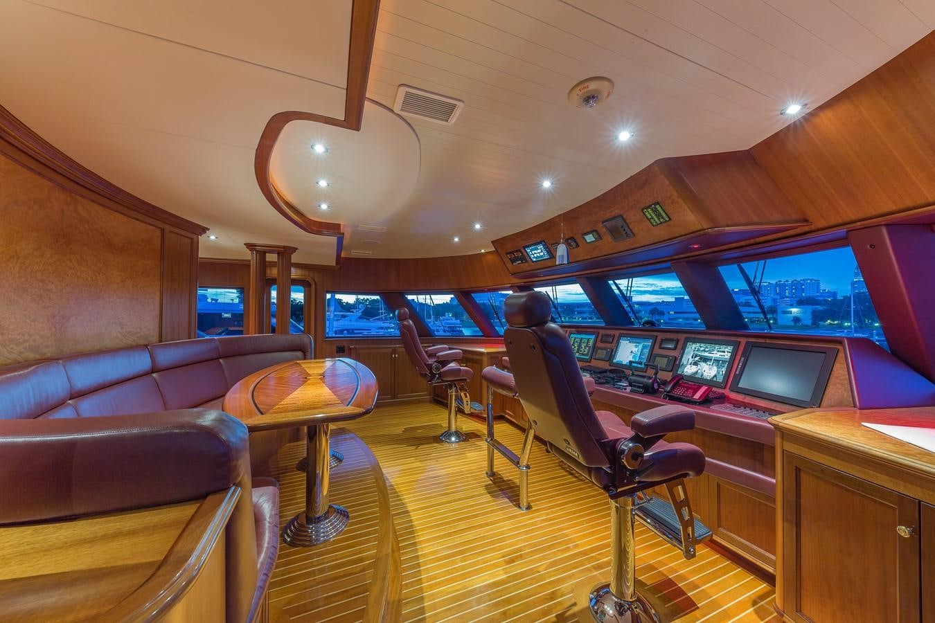 a room with a person sitting at a desk with a computer and a large screen aboard SORCHA Yacht for Sale