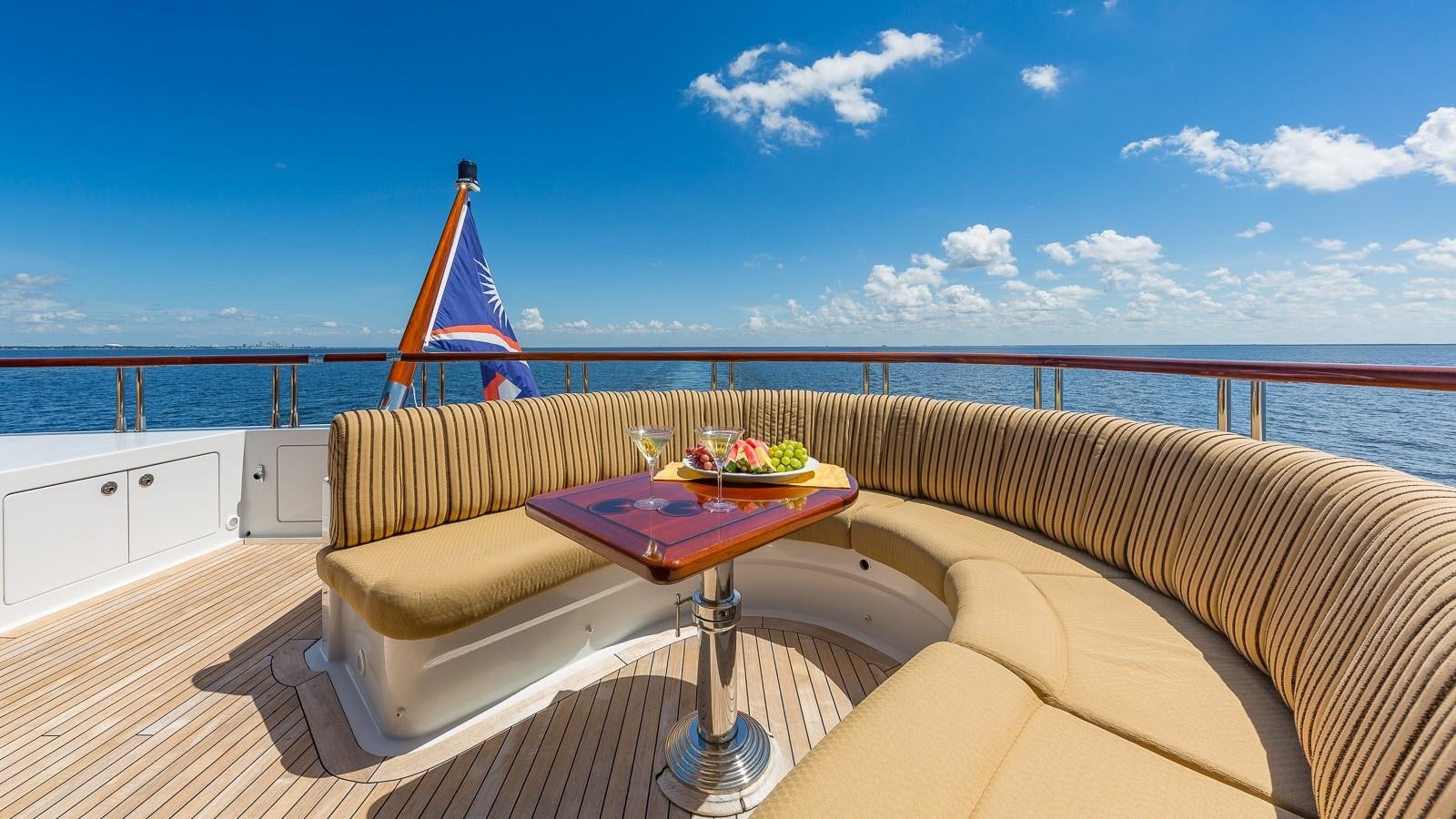 a deck with a table and chairs aboard SORCHA Yacht for Sale