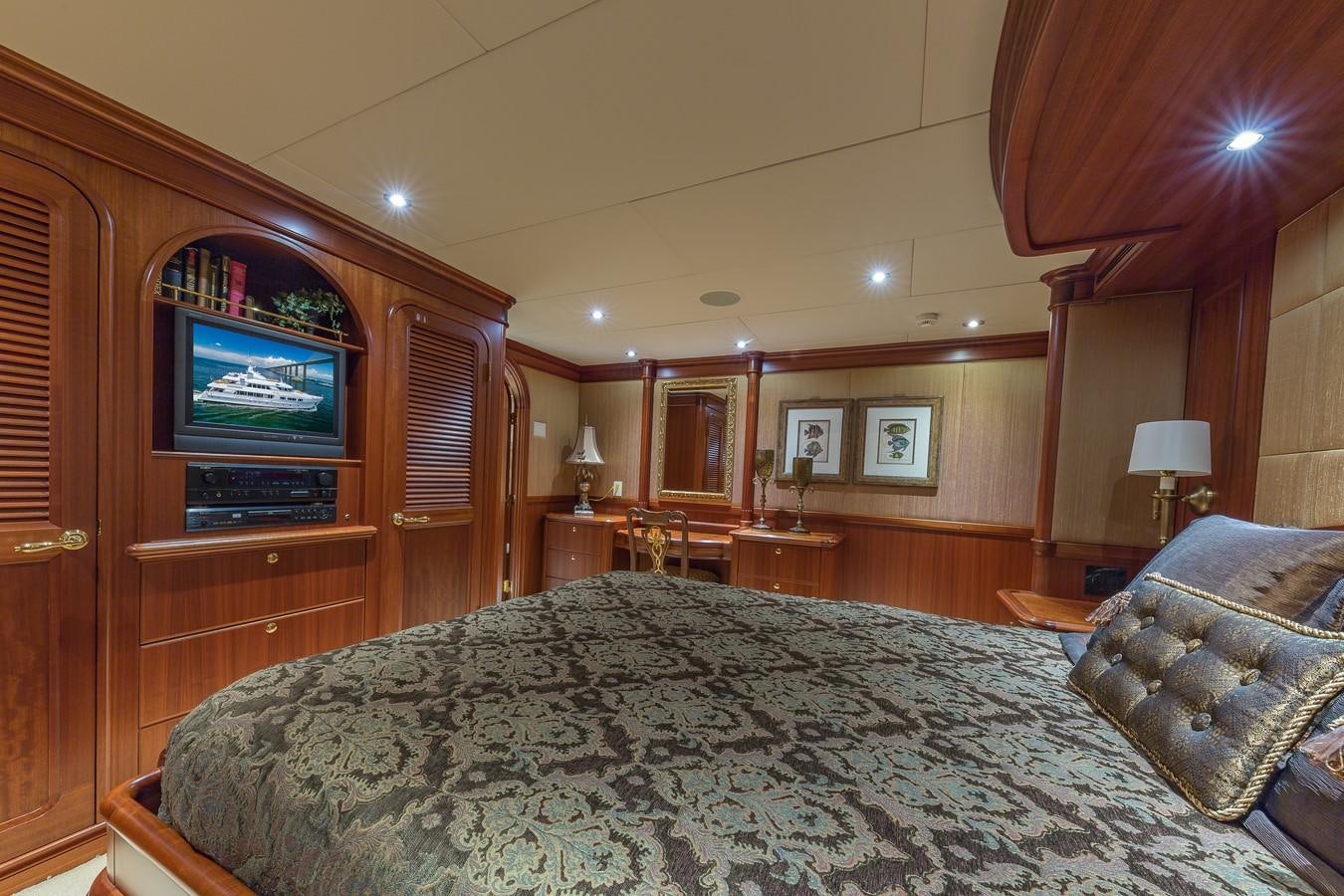 a bedroom with a bed and a television aboard SORCHA Yacht for Sale