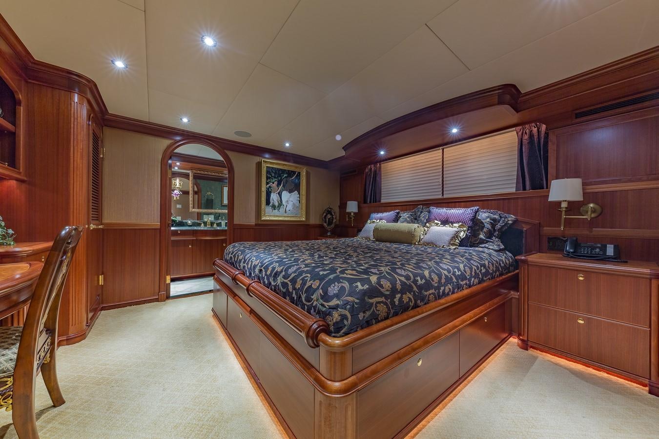 a bedroom with a bed and a mirror aboard SORCHA Yacht for Sale