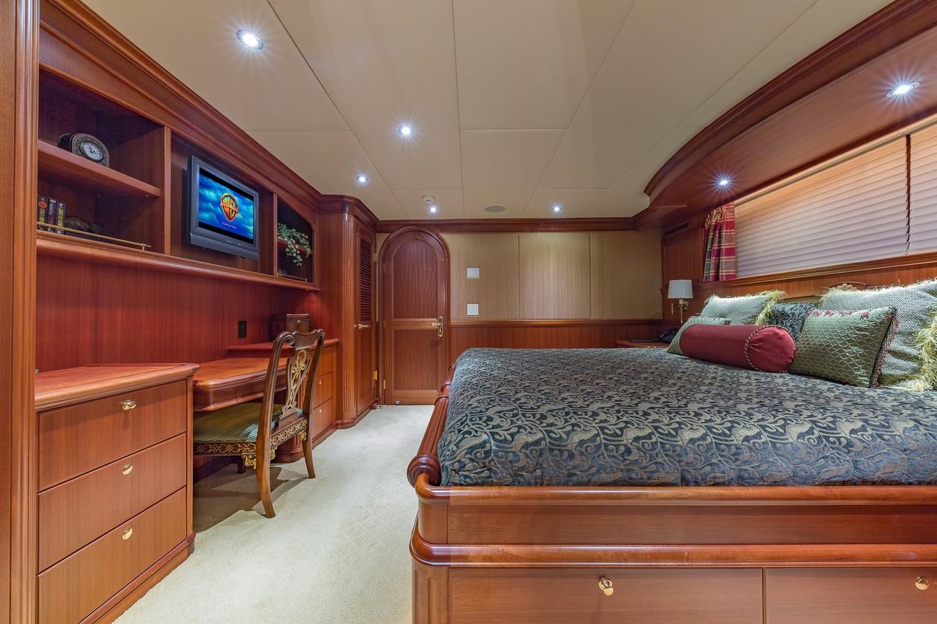 a bedroom with a bed and a tv on the wall aboard SORCHA Yacht for Sale