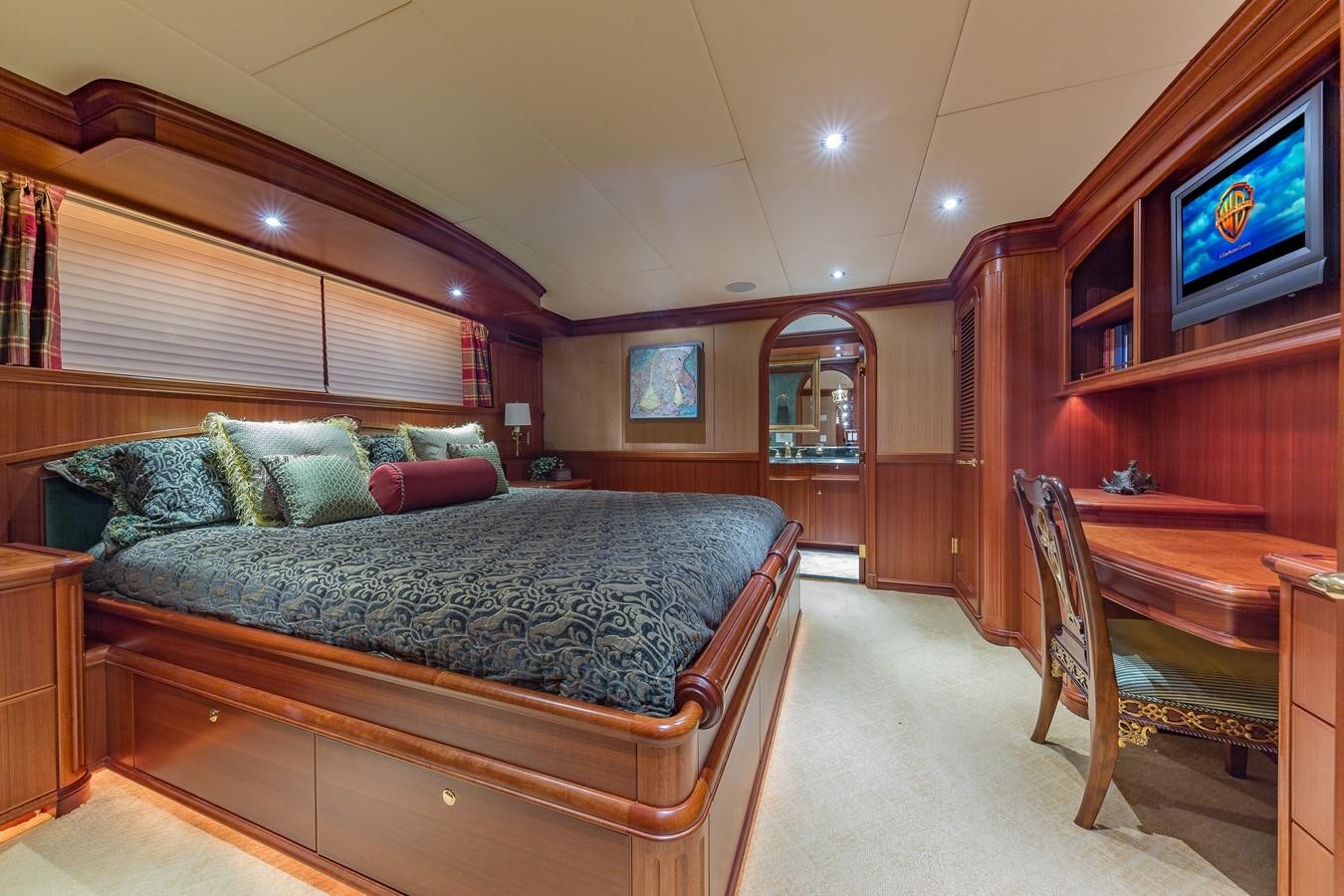 a bedroom with a bed and a television aboard SORCHA Yacht for Sale