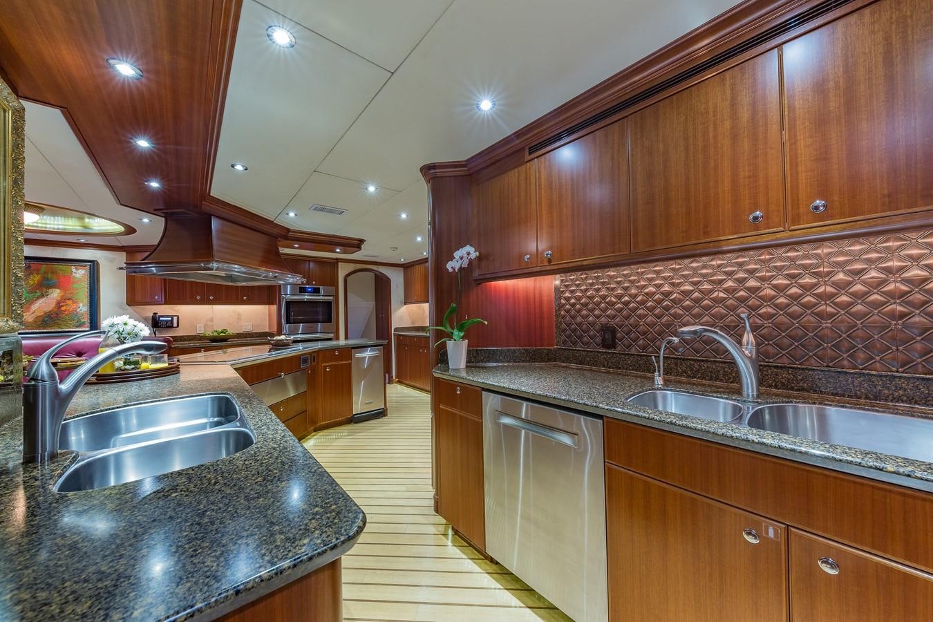 a kitchen with wooden cabinets aboard SORCHA Yacht for Sale