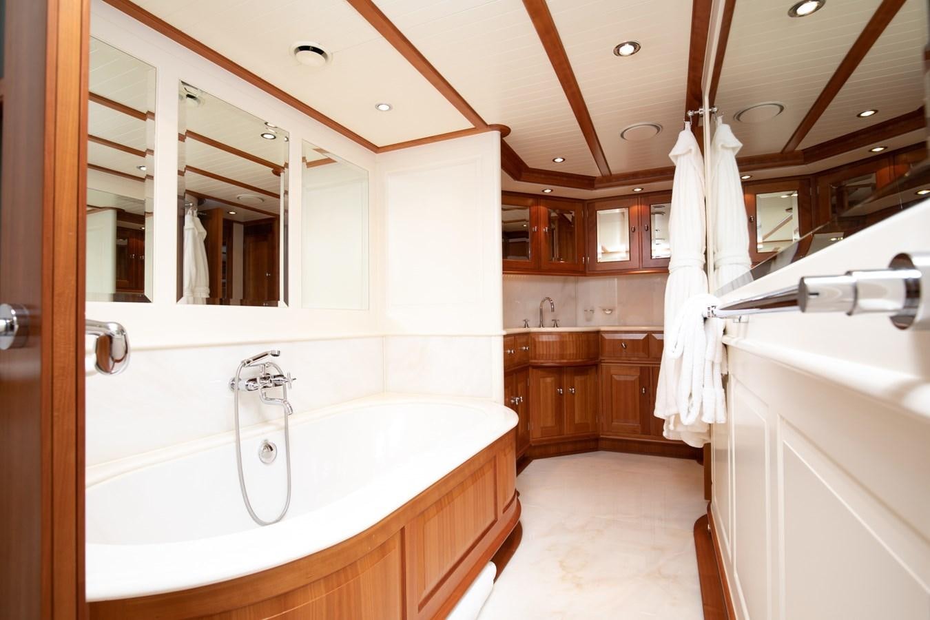 a bathroom with a tub sink and cabinets aboard WELLENREITER Yacht for Sale