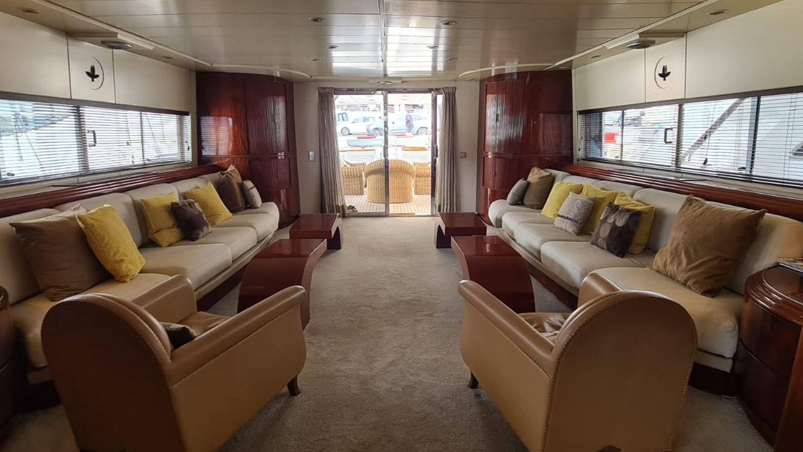 a living room with couches and a window aboard COSTA MAGNA Yacht for Sale