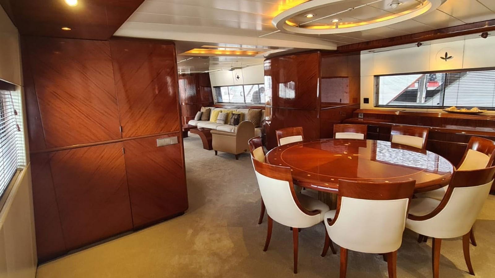 a room with a table and chairs aboard COSTA MAGNA Yacht for Sale