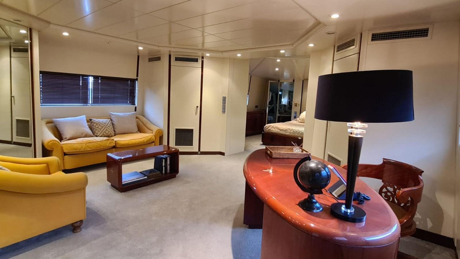 a living room with a lamp and a table aboard COSTA MAGNA Yacht for Sale